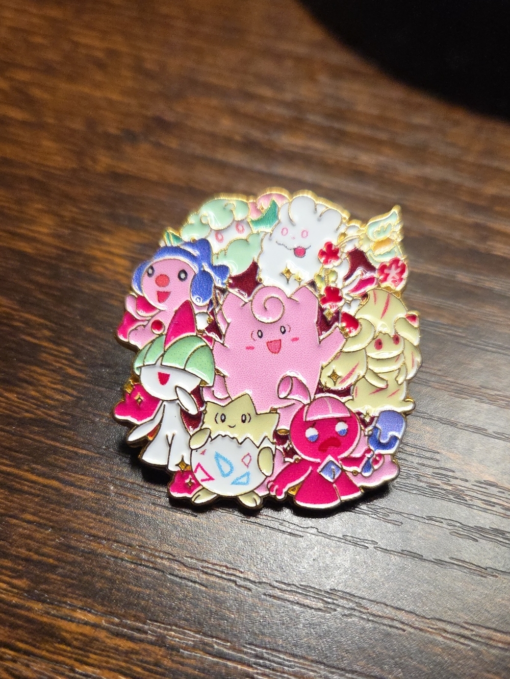 Small colorful enamel pin with cartoon characters